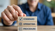 © HoneyStock - Implementing Standard Operating Procedure SOP with Wooden Blocks for Efficient Business Management Workflow