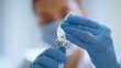 © stockbusters - Physician hands filling syringe medication closeup. Doctor preparing vaccine