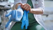 © stockbusters - Doctor hands wearing rubber gloves closeup. Unknown woman caring about sterility