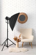 © Pixel-Shot - Modern photo studio with armchair and professional lightening equipment