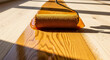 © catocala - Roller moves across wooden floor applying glossy finish quickly in well-lit room during daytime