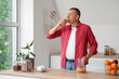 © Pixel-Shot - Mature man drinking orange juice in kitchen