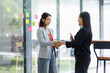 © David - Happy business asian manager handshaking client at meeting. Smiling female hr hiring recruit at job interview, insurance agent, lawyer making contract deal at work with business handshake.