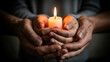 © Alex - Child and adult hands holding candle symbolizing shared memory and protection