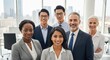 © SOEM - A diverse group of business professionals standing in an office with a city skyline in the background.
