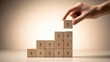 © Zihan Mia - hand stacking wooden blocks with upward arrows representing growth and progress