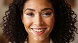 © Softistry - Beautiful young woman with curly hair smiling warmly