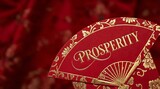 Elegant Red Fan with Golden Floral Design and the Word Prosperity.