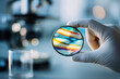 © lemonmoon - Polarized light reveals stress patterns in transparent material held by gloved hand in laboratory environment, showcasing scientific analysis and vibrant color effects