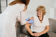 © dsheremeta - Nurse applying bandage after senior woman vaccination