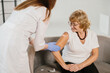 © dsheremeta - Senior woman receiving vaccination for health protection