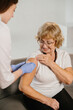 © dsheremeta - Senior woman receiving vaccination from medical staff