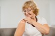 © dsheremeta - Smiling senior woman showing arm after vaccination