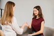 © dsheremeta - Young woman receiving vaccination shaking hands with doctor