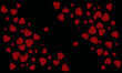© Monivara Creations - Red hearts scattered over a black background for valentine's day or romantic themed designs and backgrounds