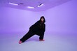 © callisto - Unique dance pose in a creative studio with purple background
