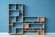 © Pixel-Shot - Empty wooden shelving units near blue wall