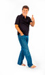 © travelview - Portrait of attractive casual man in studio showing thumbs up