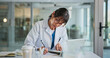 © peopleimages.com - Woman, doctor and writing in office for healthcare, prescription or notes. Patient report, administration and tech with mature medical professional and tablet for documents, schedule or planning