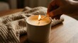 © peacefy - An intimate moment of warmth and comfort is captured as a hand lights a candle. The warm glow of the flame illuminates the scene, creating a sense of peace and tranquility.