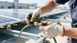 © Zucide - Engineer's gloved hands making an electrical connection to a solar panel array on a bright rooftop, vital for efficient green energy installation and robust renewable power infrastructure