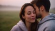 © Bussakon - A man whispers intimately into a woman s ear sharing a tender moment outdoors in the soft morning mist