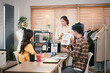 © Prathankarnpap - Three creative people in smart casual wear discussing business brainstorming meeting ideas with fashion clothes