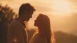 © Yuliia - Romantic couple silhouette at golden hour sunset sharing intimate moment together in warm evening light with soft bokeh background for love concepts.