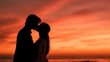 © Yuliia - Romantic couple silhouette kissing at sunset with dramatic orange sky. Man and woman in intimate moment during golden hour for love and relationship concepts.