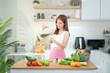© wattana - Healthy lifestyle concept with woman preparing vegetable juice.