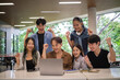 © wattana - Group of university students celebrating a successful project together on campus. Education concept.