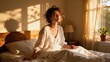 © ibhonk - Relaxed young woman sitting up in bed wearing a white nightshirt, basking in the warm golden hour sunlight streaming through the bedroom window.