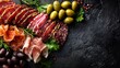© Khadiza F - Awesome photo of gourmet charcuterie board with assorted sliced salami, prosciutto, olives and fresh herbs on dark slate.