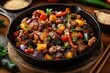 © Margarita - Hearty sizzling stir-fry of crispy diced beef with red and yellow bell peppers, purple eggplant, sesame seeds and fresh herbs in a cast iron skillet, warm and appetizing