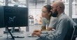 © Framestock - Focused Specialists Monitoring Factory Automation Work. Male and Female Technical Specialist Monitoring Real Time Factory Automation on Dual Screen Workstation. Process Control, Technical Oversight.