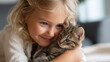 © Laura - Banner little baby girl with joyful expression nose to nose faceless, hugging tabby kitten, bright airy home, tender moment of child and domestic pet friendship, defocused backgrou