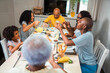 © Nexa - Happy multi-generational Black family enjoying a healthy breakfast together at home, sharing food and laughing during a weekend morning meal.