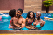 © Nexa - Happy multi-ethnic family enjoying a summer day in the swimming pool together.