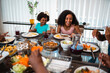 © Nexa - Happy African American family enjoying a delicious meal together at home