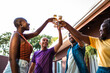 © Nexa - Diverse group of friends and family toasting with beer glasses during a backyard celebration.