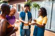© Nexa - Diverse group of happy friends and family enjoying a backyard party with beer and snacks on a sunny day.