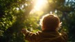 © sangNaga. - A child with outstretched arms greets sunlight filtering through lush green foliage