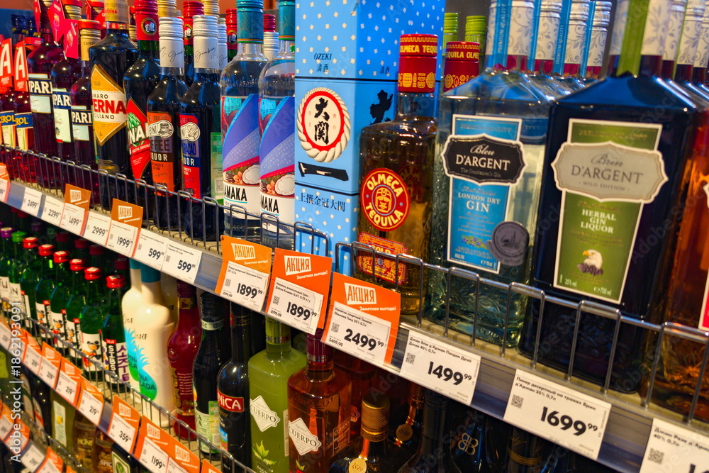 Liquor store shelf displays various alcoholic drinks and beverages in ...