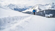 © Vera - Man skiing on snowy mountain trail with stunning alpine landscape