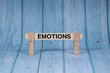 © pandeeswari - Emotions symbol. Wooden stick clamped by Clothespins, vivid blue wooden backdrop. Business and Emotions concept with copy space