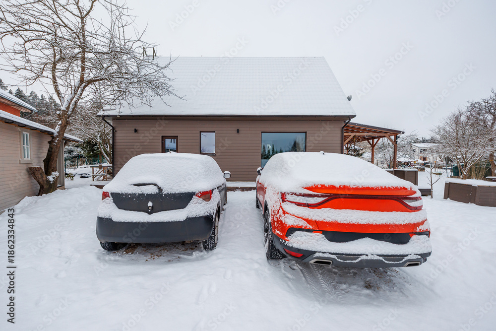 Photo inspiration: Fresh Look at Two Cars Charcoal And Bright Red Sit Under Fresh Snow