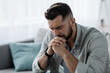 © Prostock-studio - Unhappy depressed caucasian handsome bearded man crying in living room couch, feeling desperate and lonely, isolated at home. In stressed from work, unemployment, anxiety, heartbroken and depression