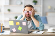 © Prostock-studio - Tired young man having stickers with open eyes drawing on his glasses, sleeping in front of laptop at home office. Exhausted millennial man overworking, napping, failing to meet deadline