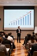 © Gustav - Professional speaker presenting business growth statistics to an attentive audience in a