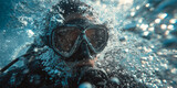 Scuba diver in full gear exploring underwater environment with bubbles and blue water